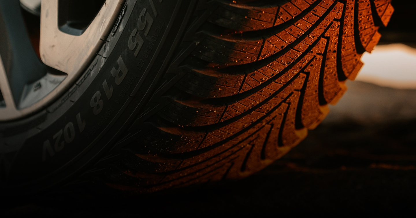 Close up of a Kumho tire speckled with sand